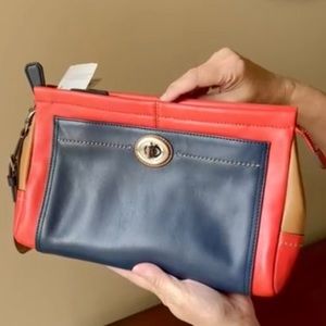 Coach, Color block-leather Large zippered Wristlet/Clutch. Brick red, Navy/Tan.